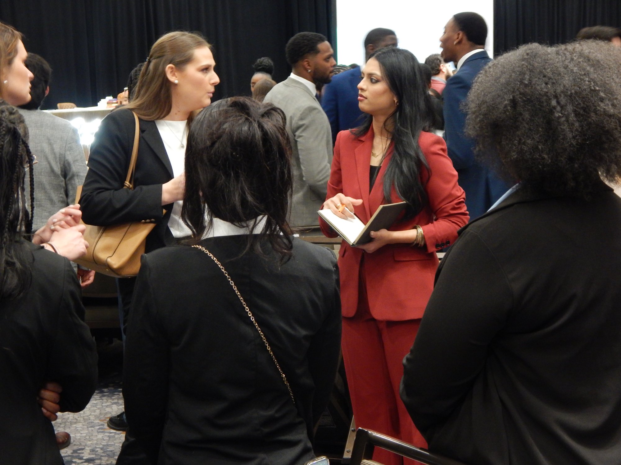 Azalea Acquisitions team networking at a professional conference